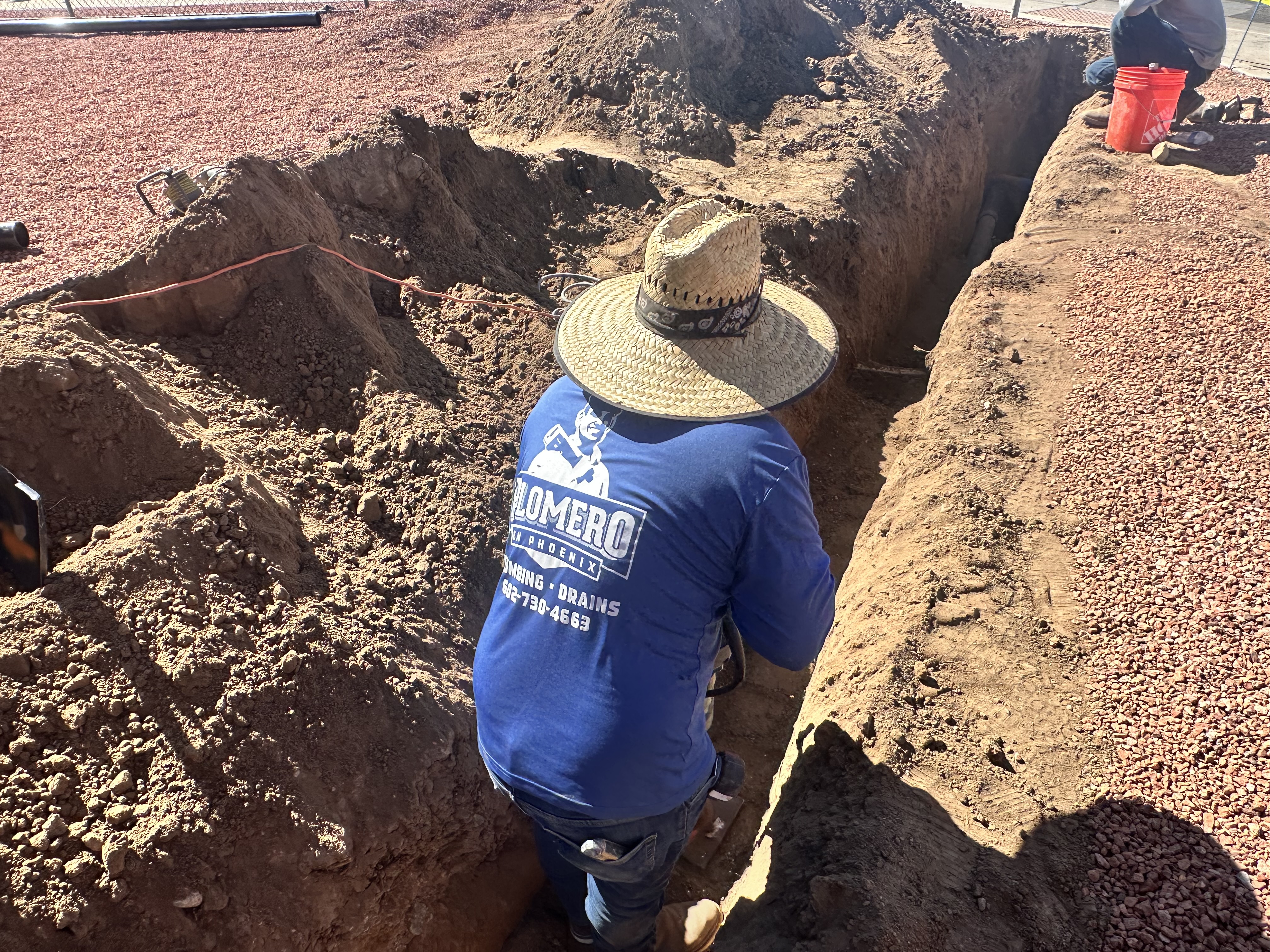 Sewer trench excavation Phoenix plumber working on sewer line replacement