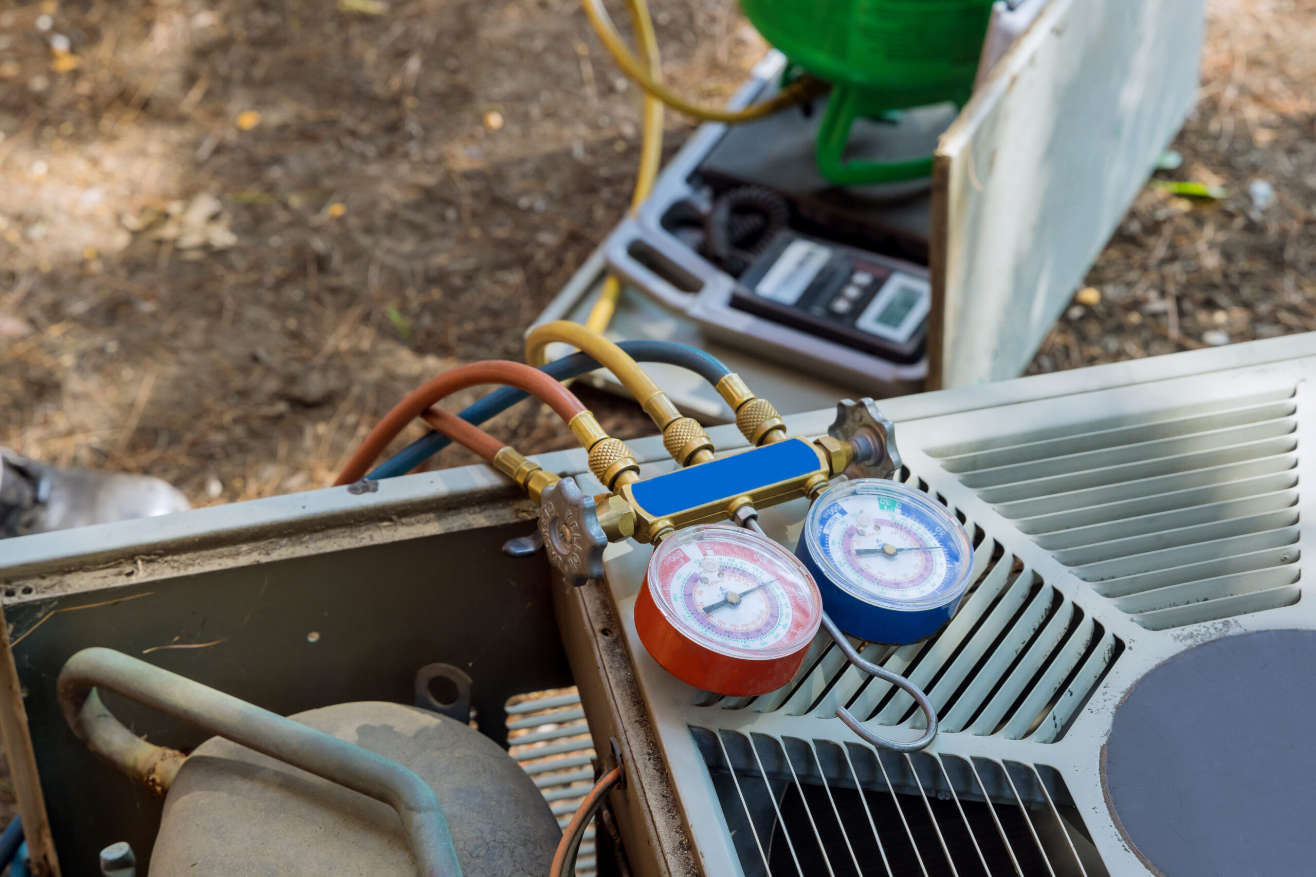 HVAC technician testing an air conditioner capacitor and checking for signs my AC capacitor is about to fail during a residential AC maintenance inspection.