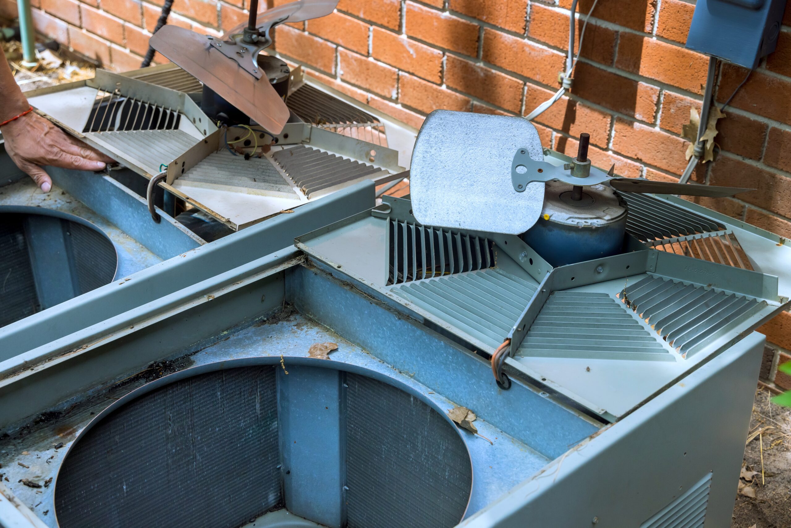 HVAC technician performing a preventive AC inspection before the summer season.